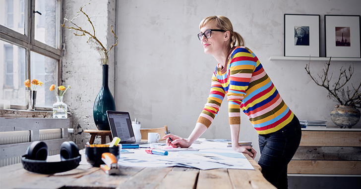 woman stands at desk