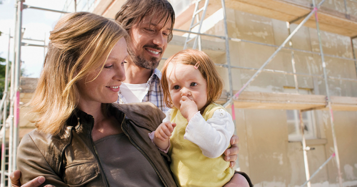 Man, woman, and toddler at home construction site