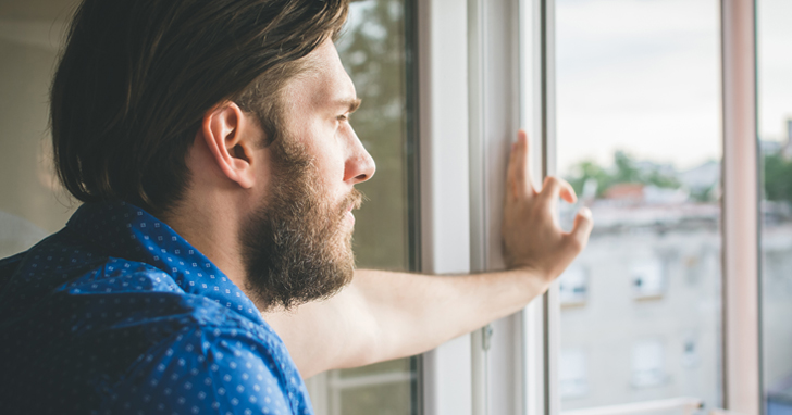 Man staring out window