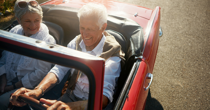 Couple enjoys time on the beach. Are you saving enough for retirement?