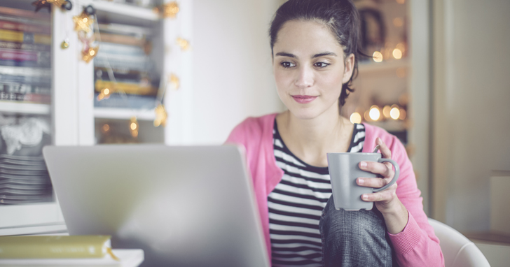 Woman looks for phishing emails on computer
