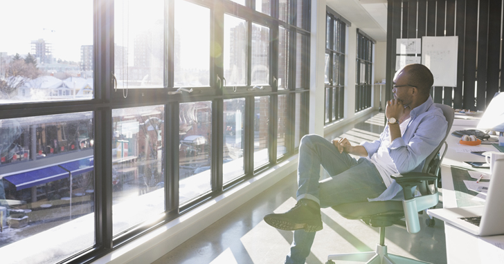 Man gazes out the window in deep thought
